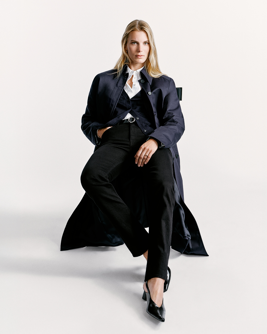 woman in black denim and long navy coat